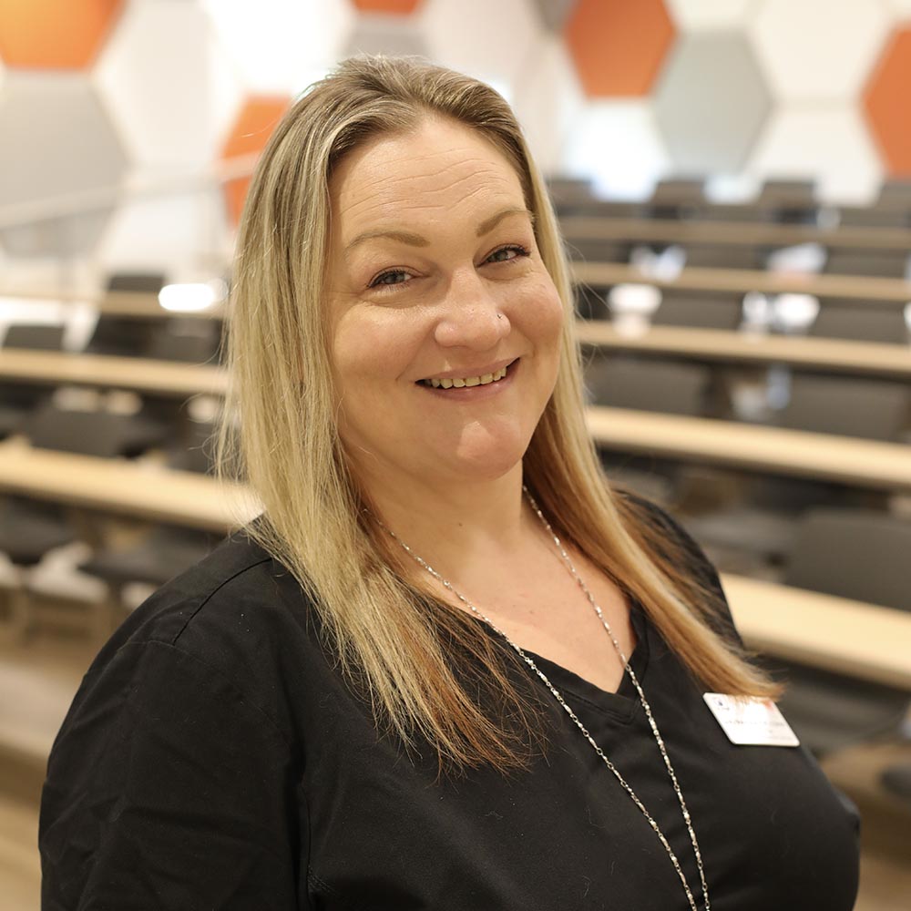 Amy Rapplean in a classroom posing for a photo