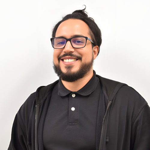 Felix posing for a photo against a white wall