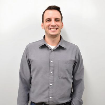 William Gardner posing for a photo against a white wall