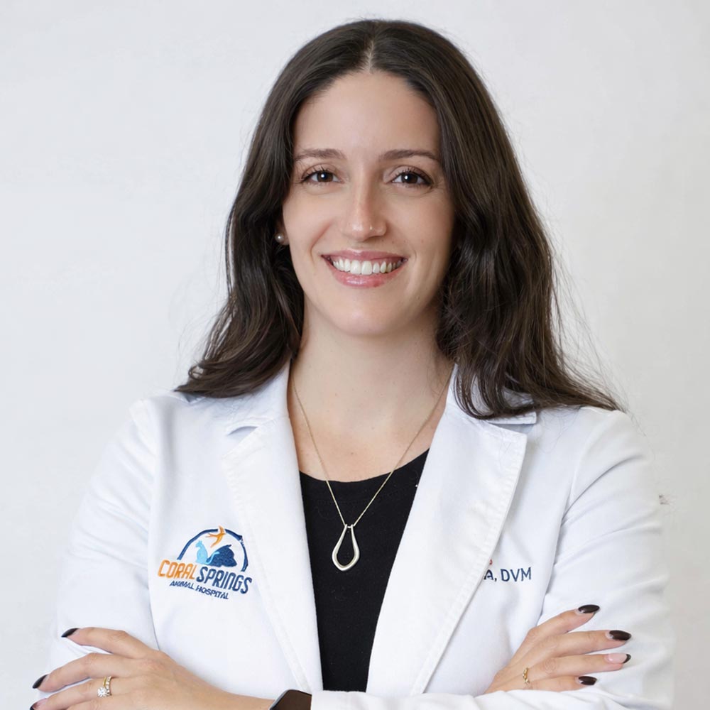 Dr Pam Colareta posing for a photo against a white wall