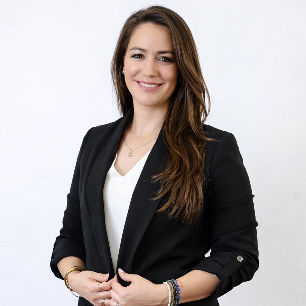 Vivi Restrepo posing for a photo against a white wall