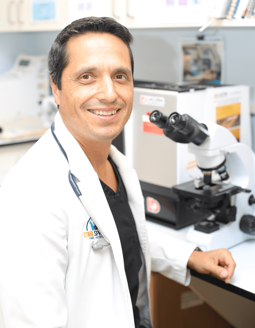 Doctor Smiling In Front Of Microscope
