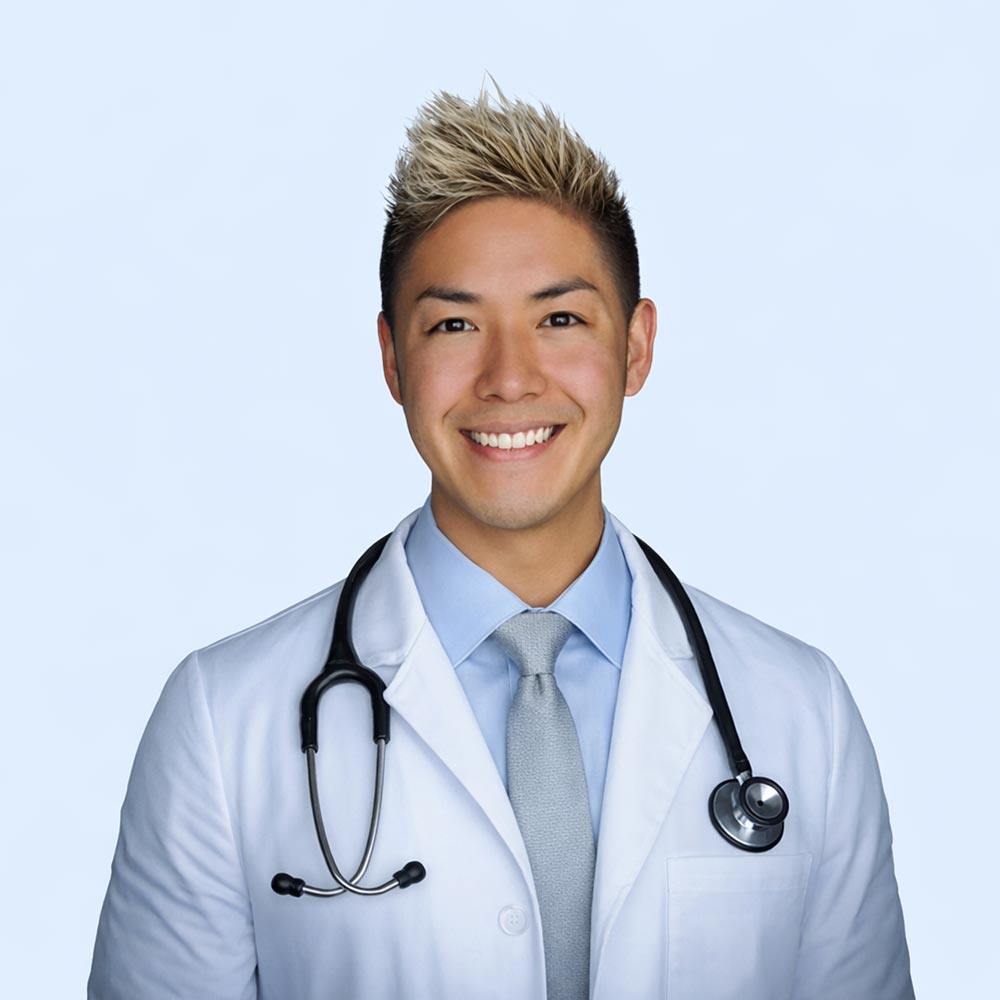 Dr Jordan Vitt posing for a photo against a white wall