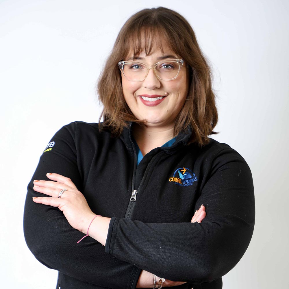 Monica Finn posing for a photo against a white wall