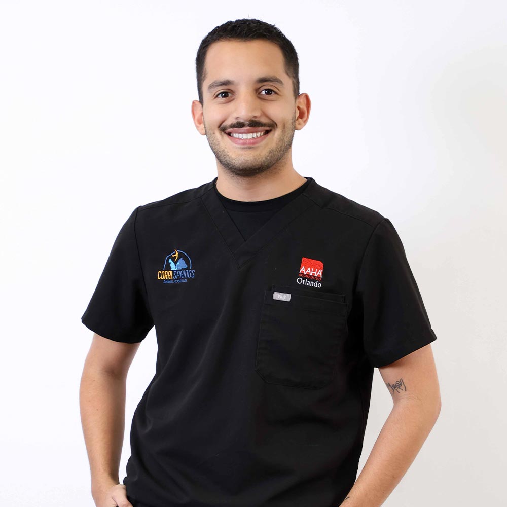 Orlando Trujillo posing for a photo against a white wall