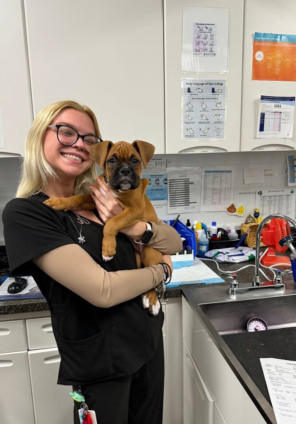 Blond Vet Tech Holding Puppy